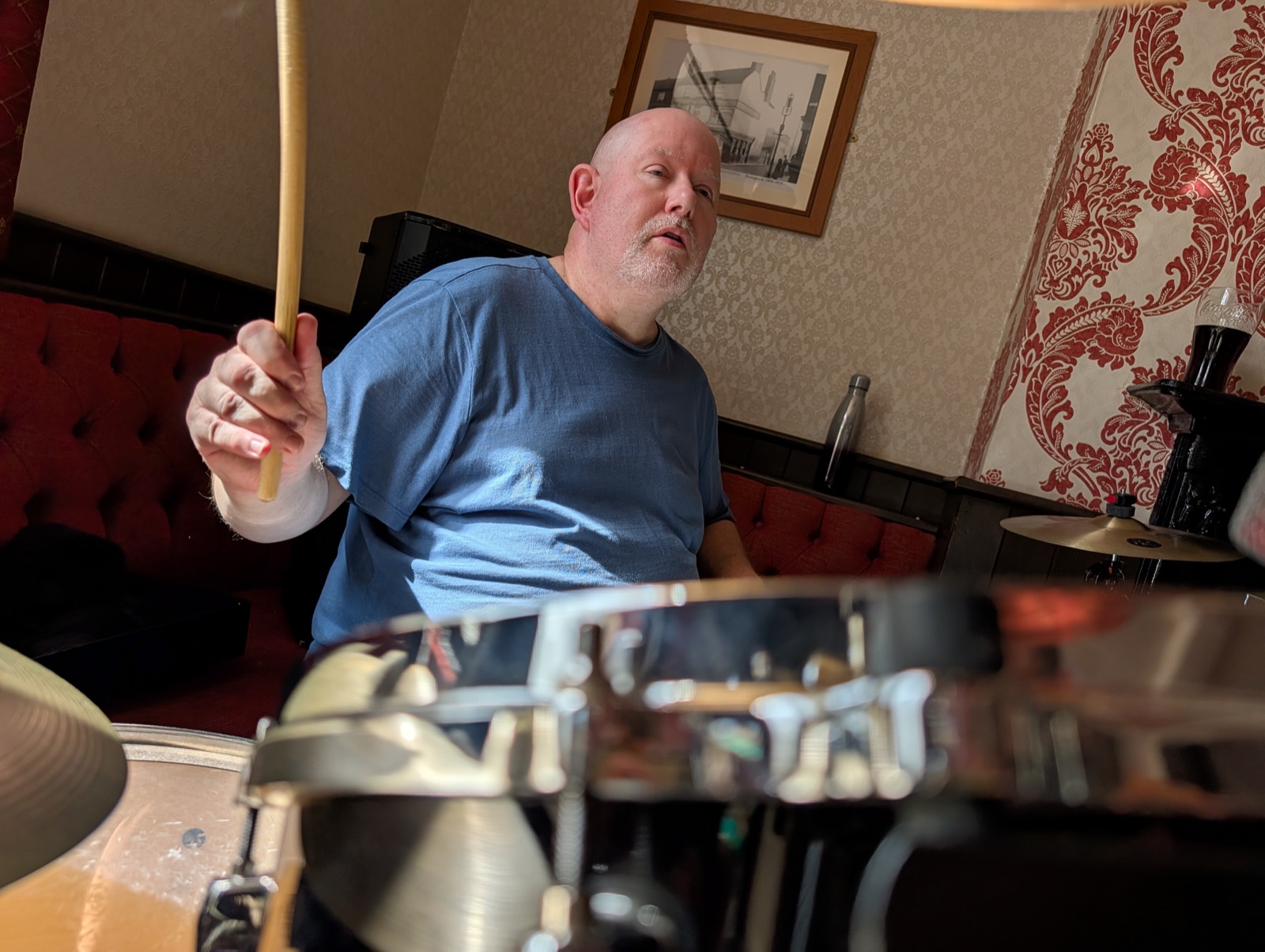 Mike Croydon with stick raised behind the drum kit